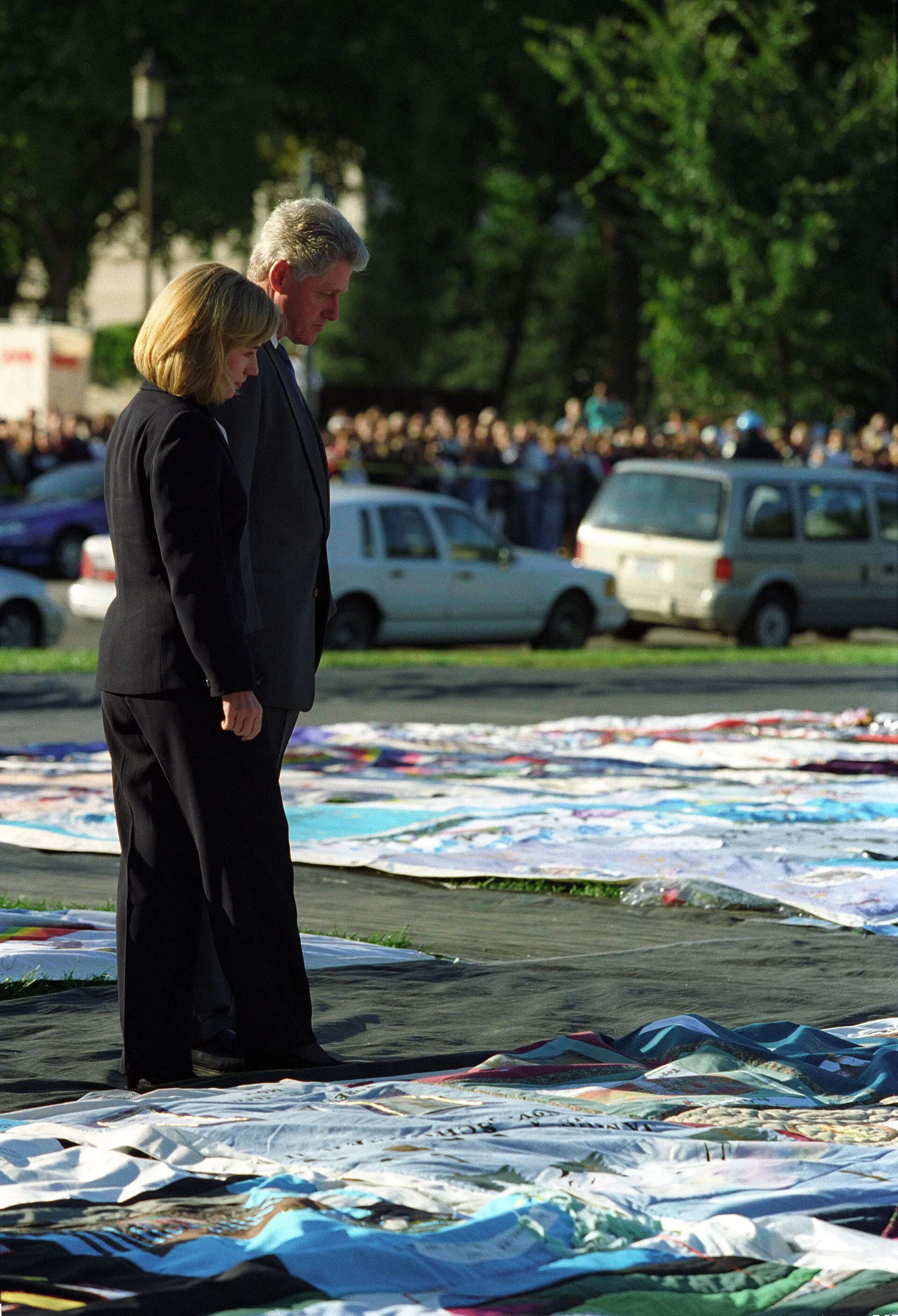 Panels of the AIDS Memorial Quilt spread across the National Mall in Washington, with visitors walking among them.