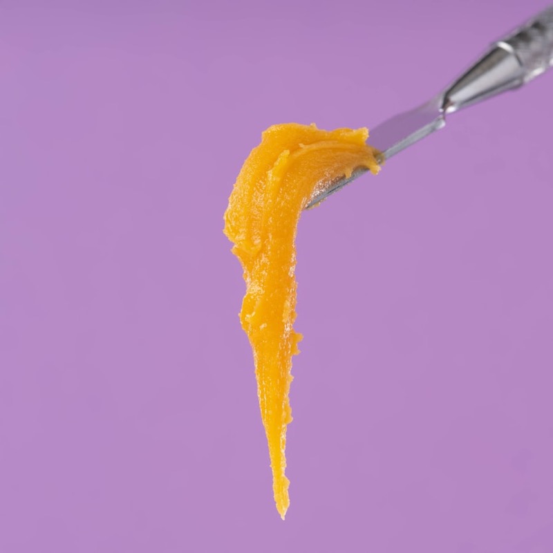 Golden cannabis concentrate on a dab tool